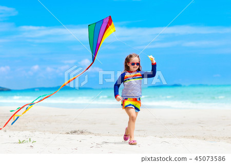 Child with kite. Kids play. Family beach vacation. 45073586