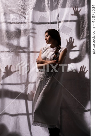 Sexy girl shot against white sheet and shadows Sexy girl shot against white sheet and shadows 45075534