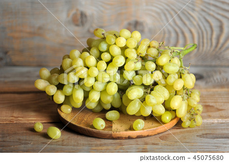 bunch of green grapes on wooden Board 45075680