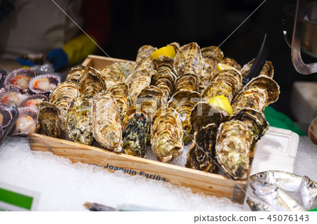 Selling oysters. La Boqueria market in Barcelona 45076143