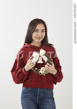 Girl holding Christmas wreath Girl holding Christmas wreath 45076307