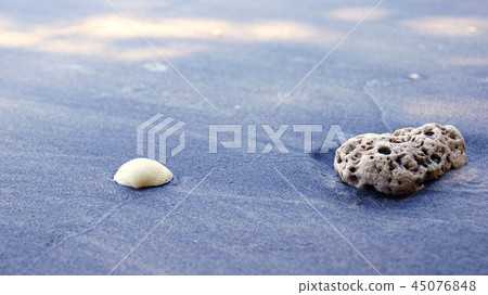 PULAU LANGKAWI, MALAYSIA - APR 7th 2015: Famous black sand beach with closeup of stone 45076848