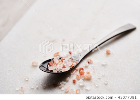 Spoon of pink himalayan salt on white marble 45077381