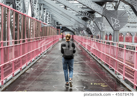 Solo casual woman walking the cycling lane on Williamsburg Bridge, Brooklyn, New York City, USA Solo casual woman walking the cycling lane on Williamsburg Bridge, Brooklyn, New York City, USA 45078476