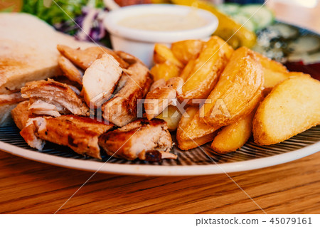 Dish with grilled chicken meat and fryed potato Dish with grilled chicken meat and fryed potato 45079161