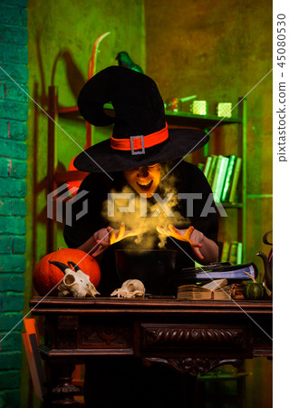 Image of witch of saucepans with magic potion 45080530