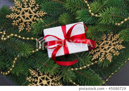 Gift box and christmas tree branches Gift box and christmas tree branches 45080729