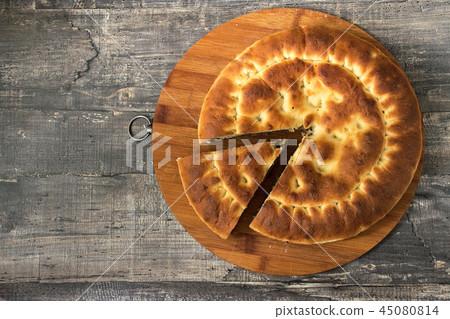 Round pie on dark wooden desk background. Top view Round pie on dark wooden desk background. Top view 45080814
