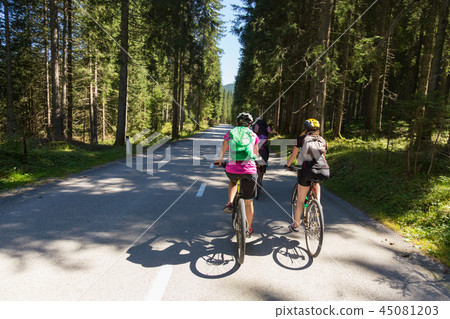 Active sporty women riding mountain bike on forest trail . 45081203