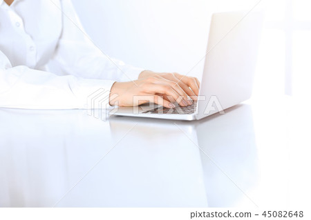 Close-up of business woman hands typing on laptop computer. Secretary at work in office 45082648