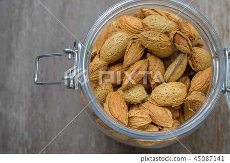 Close up of Almond seeds in the glass jar  45087141
