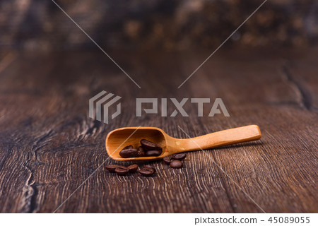 Coffee grains and wooden spoon on the old table 45089055