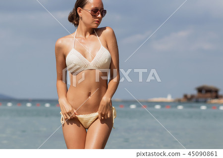 Woman untying swimwear panties Woman untying swimwear panties 45090861