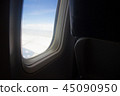 Plane in window view with the seat traveling  45090950