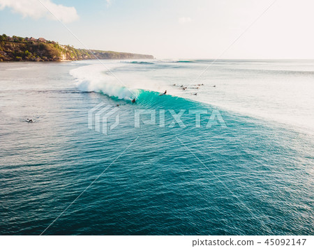 Aerial view with surfers and turquoise barrel wave Aerial view with surfers and turquoise barrel wave 45092147