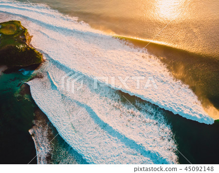 Aerial view of big waves at warm sunset and coast. Aerial view of big waves at warm sunset and coast. 45092148
