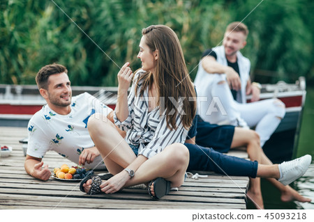 Young pretty woman and handsome man flirting while relax on picn 45093218