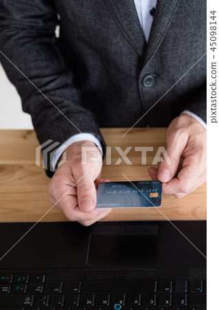 man holding credit card laptop online banking man holding credit card laptop online banking 45098144