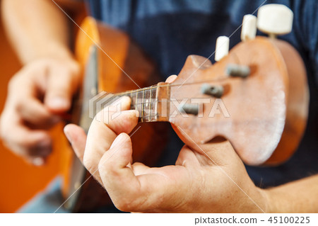 man playing the mandolin. hands closeup 45100225