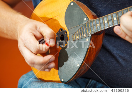 man playing the mandolin. hands closeup man playing the mandolin. hands closeup 45100226