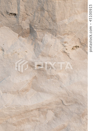 Closeup limestone rock face with weathered strata 45100915