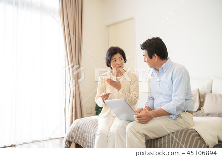Senior couple personal computer bedroom lifestyle image Senior couple personal computer bedroom lifestyle image 45106894