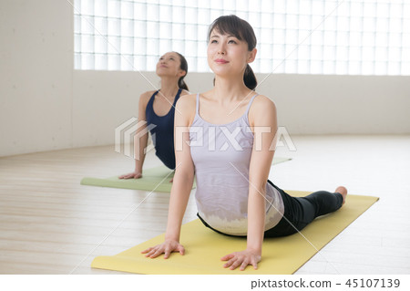 Young Japanese woman taking yoga lesson in yoga studio 45107139