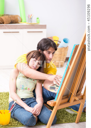 Young couple enjoying painting at home Young couple enjoying painting at home 45109296
