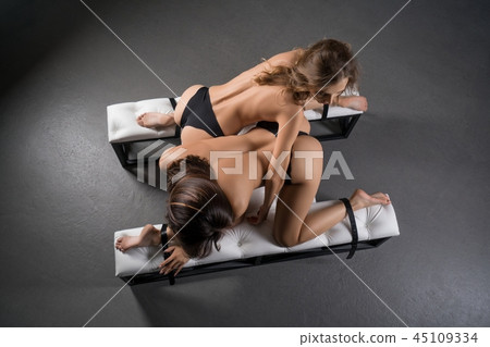 Girls topless on their knees high angle view Girls topless on their knees high angle view 45109334