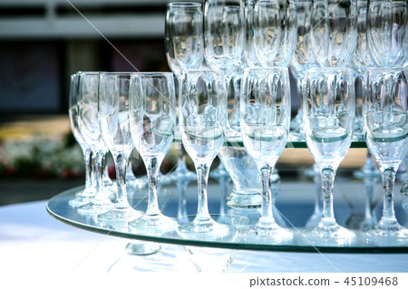 Summer outdoor wedding ceremony decoration. champagne wine glass pyramid on a party, wedding Summer outdoor wedding ceremony decoration. champagne wine glass pyramid on a party, wedding 45109468