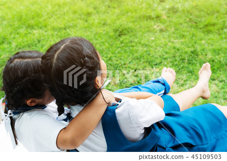 two little asian girls sisters hugging happy post 45109503