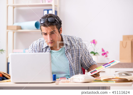 Young handsome tailor working in his workshop 45111624