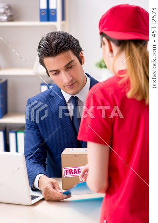 Courier delivering parcel to the office 45112573