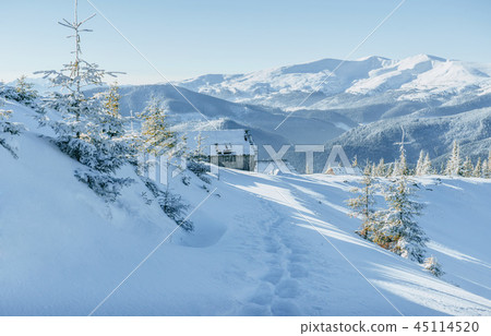 Cabin in the mountains in winter. Mysterious fog. In anticipatio 45114520