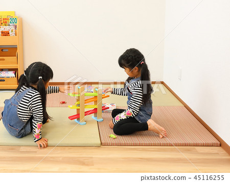 Twin girls playing in the kids room at the dentist Image Twin girls playing in the kids room at the dentist Image 45116255