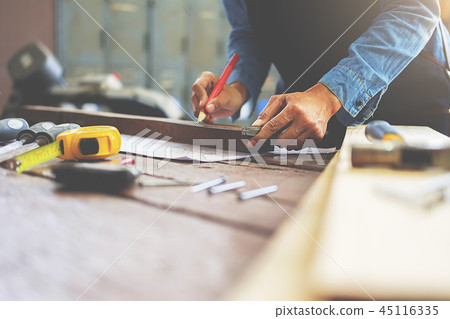 Carpenter working on woodworking machines Carpenter working on woodworking machines 45116335
