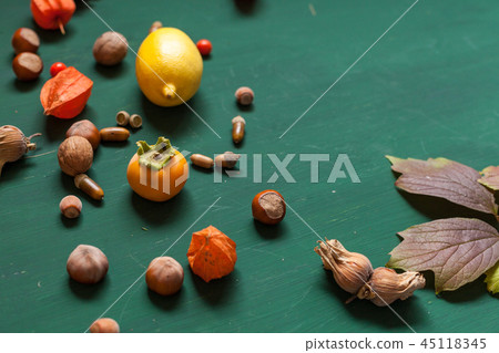 autumn yellow and Red leaves and fruits on a green background 45118345
