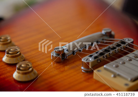 Electric guitar body and neck detail on wooden 45118739