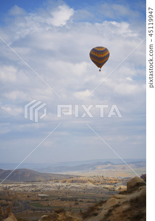 Hot air balloon flying over the rocky land Hot air balloon flying over the rocky land 45119947