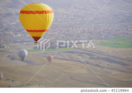 Three air balloons flying over the land 45119964