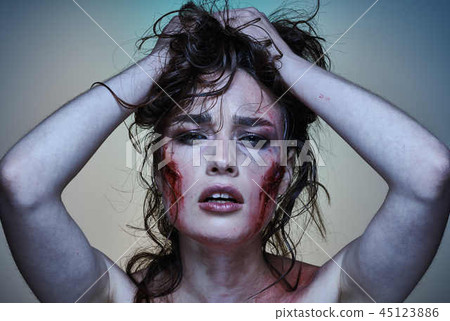 Beautiful girl with a wounded face in the blood 45123886