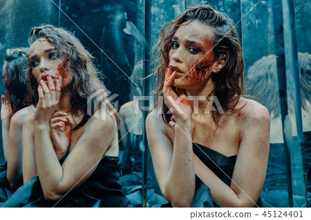 Beautiful girl with a scared face in the blood  45124401