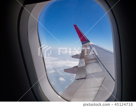 Airplane wing over blue sky and white cloud 45124718