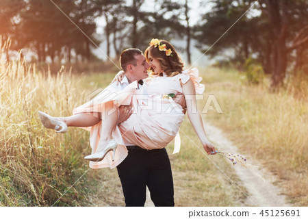 Happy young couple in a pine forest in summer Happy young couple in a pine forest in summer 45125691