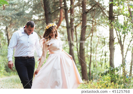 Happy couple in a pine forest Beauty world Happy couple in a pine forest Beauty world 45125768