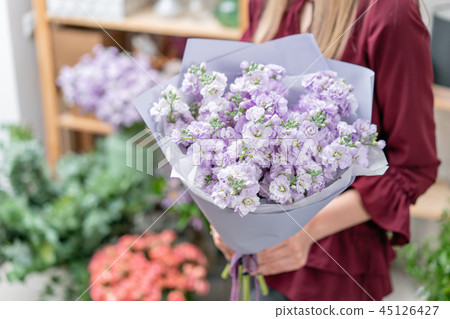 European floral shop. Two Bouquet of beautiful lilac flowers in woman hand. Excellent garden flowers European floral shop. Two Bouquet of beautiful lilac flowers in woman hand. Excellent garden flowers 45126427
