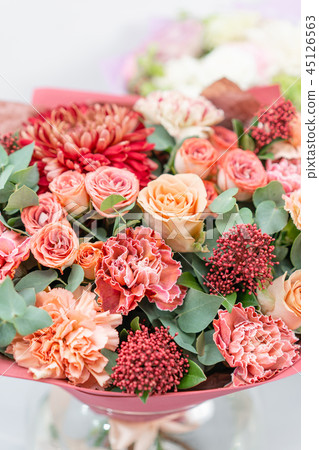 European floral shop. Bouquet Mixed beautiful flowers on wooden gray table. Nice garden flowers in European floral shop. Bouquet Mixed beautiful flowers on wooden gray table. Nice garden flowers in 45126563