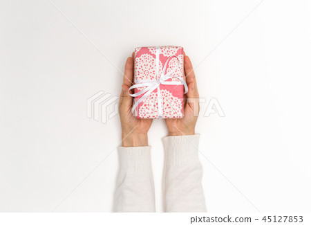 Person holding a Christmas gift box 45127853