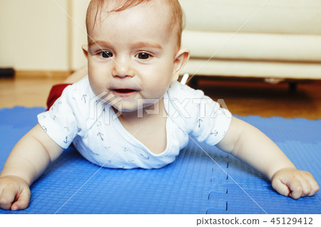 little cute baby toddler on carpet  close up smiling, adorable k 45129412