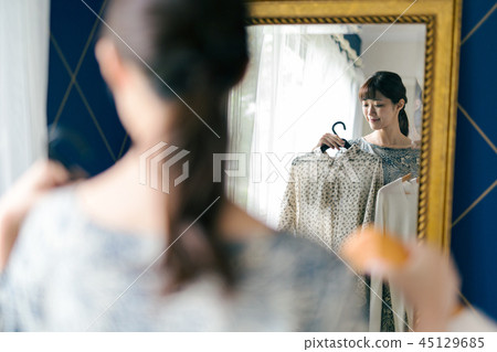 Choosing clothes women mirror 45129685